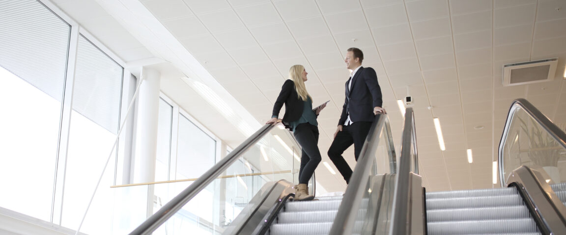 Woman and man in escalator