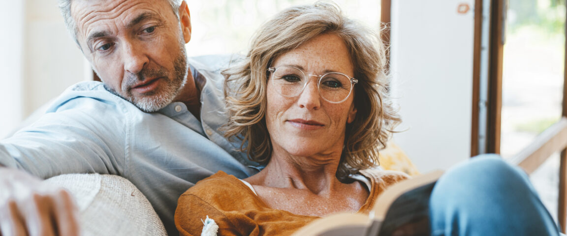 man and woman reading a book