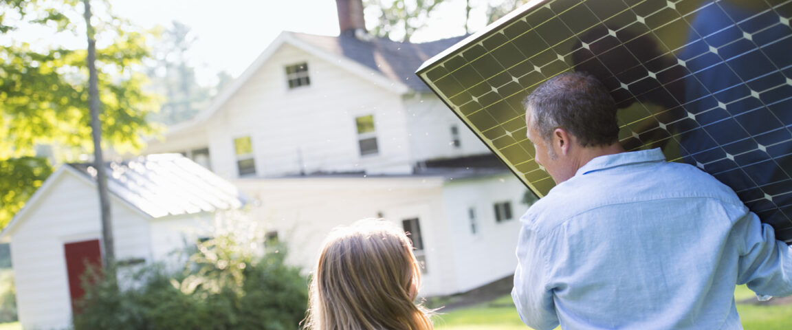 A man carrying a solar panel