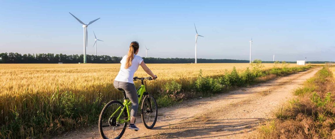 Woman cycling at countryside